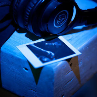 Cover image with photograph of a polaroid taken during the live set.