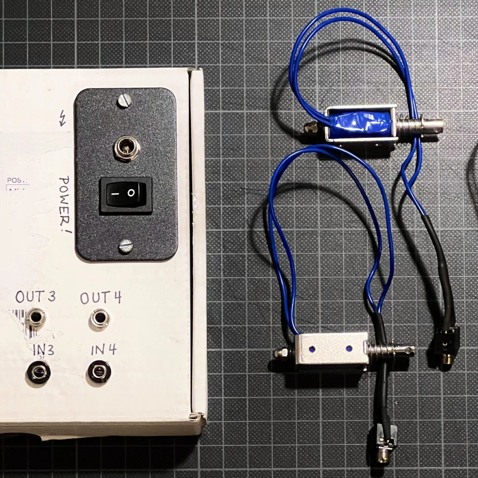 A small opto-isolator box built from a readymade board and Eurorack-compatible jacks. Connecting solenoids or any other components that draw a high electrical load is usually dangerous with Eurorack modular synths. While the ±12V sounds quite powerful, many bus boards only deliver around 1-5A. To not risk any damage to any of the modules in the system, I use a prefabricated opto-isolator MOSFET board made for usage with light fixtures.